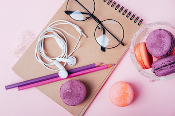 Office supplies for young woman. Flatlay with blanknote, pencils and cookies.