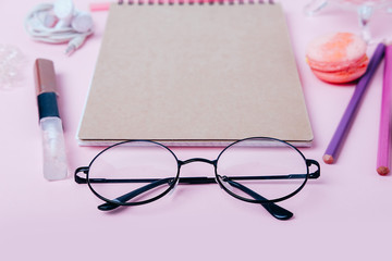 Office supplies for young woman. Flatlay with blanknote, pencils and cookies.