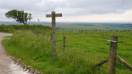 Fingerpost on the South Downs Way with Brighton in the distance