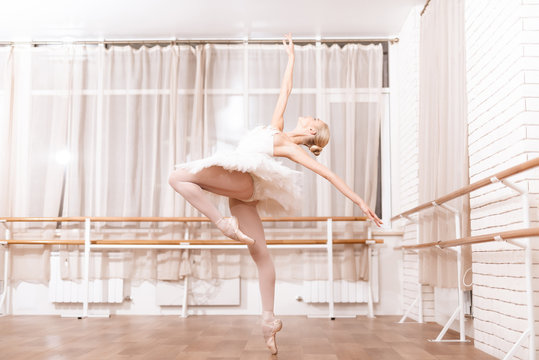 Professional dancer rehearses in ballet class.