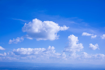 The white cloud on the blue sky in the bright day is suitable for being the nice background from the view of the highest point of Thailand. There are mountains being far at the below of the pic.