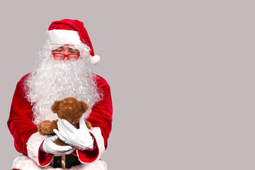 Santa claus have a teddy for children,merry christmas,Gifts for Children,Portrait of santa claus on white background,December is the month of Christmas.