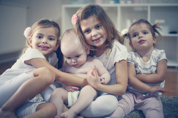 Little brothers and sisters poses to camera.