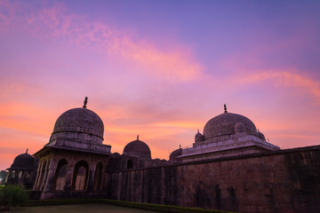 Mandu India, afghan ruins of islam kingdom, mosque monument and muslim tomb. Colorful sky at sunrise.