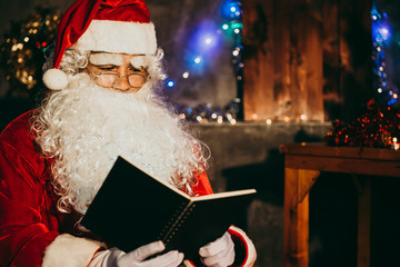 Santa claus read a book at night in the house,The light from the book,Using the light from the lantern room