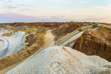 Clay and chalk slopes of the quarry for extraction of minerals. Hilly scape.