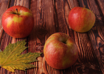 Fresh, ripe apples on an old wooden table. Fruit to comply with the diet