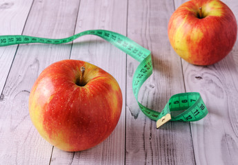 Fresh, ripe apples on an old wooden table. Fruit to comply with the diet