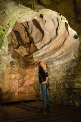 Fototapeta na wymiar the girl is interested in a karst cave