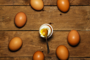 Eggs boiled. On a wooden table with a spoon.
