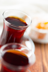Red tea in turkish glasses on a wooden table