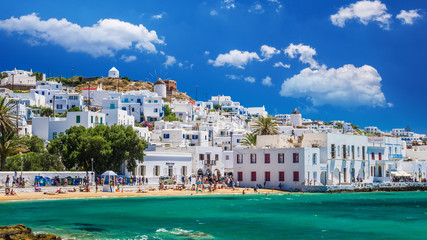 MYKONOS, GREECE - JULY 4, 2017:  Beautiful view of Mykonos town in Cyclades Islands. There are white houses and boats in the old harbor. - obrazy, fototapety, plakaty