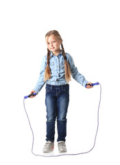 Cute little girl playing with jumping rope on white background