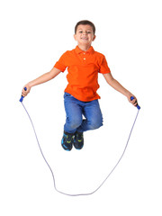 Cute little boy playing with jumping rope on white background