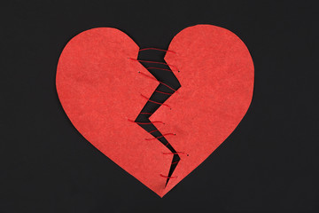 Red broken heart on a dark background