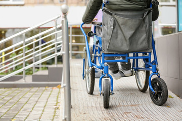 Paralyzed man in wheelchair on ramp outdoors