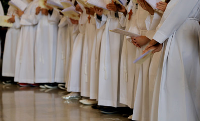 children with white tunic during the religious rite of the First
