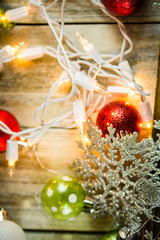 Fototapeta na wymiar Christmas Holiday Lights and Ornaments on Wood Background
