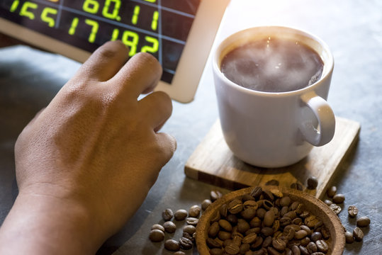 Investors use the tablet to view stock quotes online with hot coffee in the retro coffee shop.