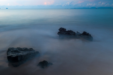 Fototapeta premium dark mystical photo - sea waves and cobblestones on the beach close up