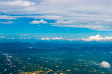 beautiful view of the fields, clouds and mountains from the airplane