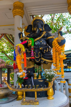 sculpture of Ganesha God with flowers close-up on the street