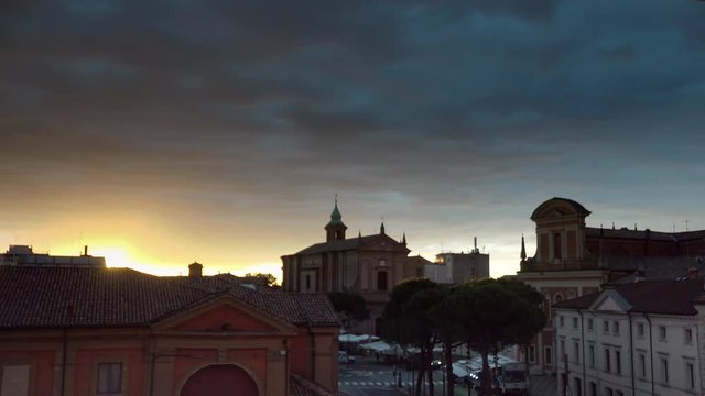 timelapse shot of sunrise on small Italian village with ancient church and buildings