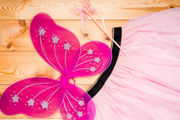 beautiful costume of a butterfly princess for a young girl on wooden boards