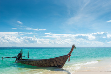 Fototapeta na wymiar Poda Island, view of the wooden boat long tail from the sandy beach, Thailand