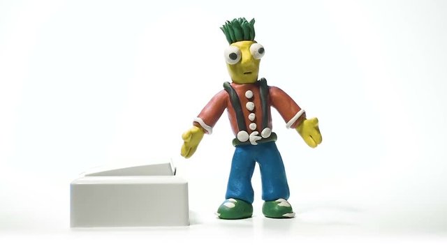 Handmade plasticine man switching light