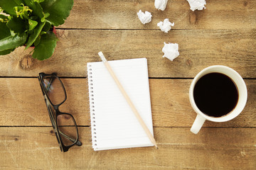 Naklejka na ściany i meble Notebook with drinking coffee on wooden table