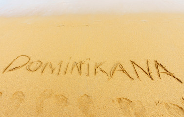 exotic vacation. Dominican republic written on the sand