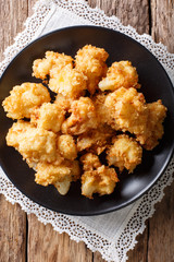 Vegetarian meal: fried cauliflower in breadcrumbs closeup. Vertical top view