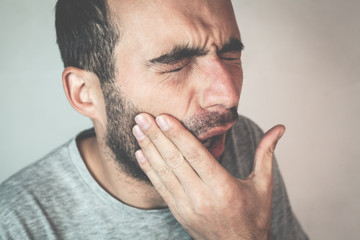 Fototapeta premium Caucasian man suffering toothache.