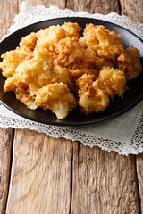 Vegetarian meal: fried cauliflower in breadcrumbs closeup. vertical