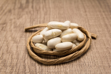 Navy Bean legume. Paper rope around grain. Selective focus.