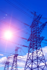  high-voltage  power lines at sunset.