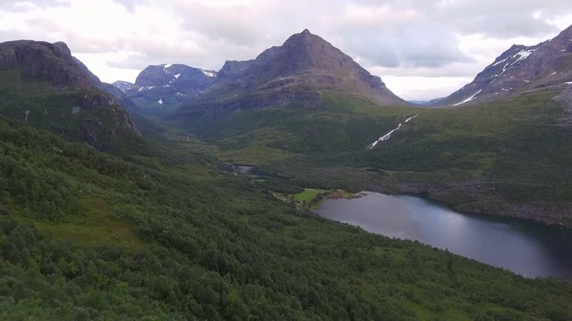 Aerial drone footage above the green forest on the mountain side. View of Innerdalen - Norway&rsquo;s most beautiful mountain valley