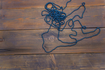  garland of blue beads on a wooden table