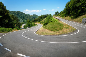 Road curve in countryside at sunny noon