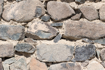 natural heavy rocks and bricks wallpaper. Stones and bricks used for construction and natural sand embedded between layers of rocks.
