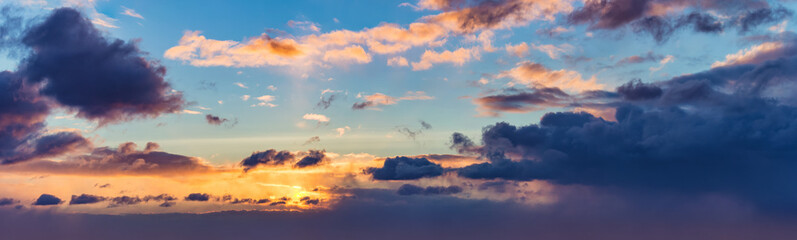 Naklejka na ściany i meble background panorama. rays of the sun make their way through dramatic clouds
