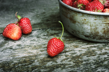 Red, ripe strawberries on a wooden table