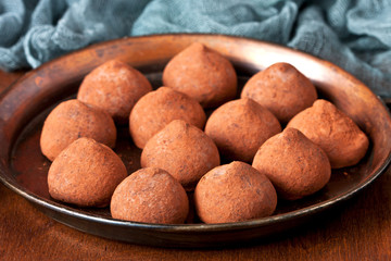 Chocolate truffles on plate. Selective focus