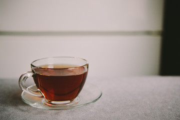 Glass cup of black tea on the kitchen