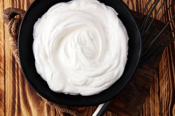 close up of a white whipped or sour cream in bowl