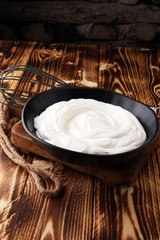 close up of a white whipped or sour cream in bowl