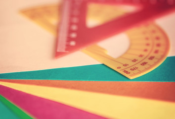 School supplies. Close up of a protractor and ruler with shallow depth of field.