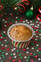 Homemade muffin with star decoration on wooden background.