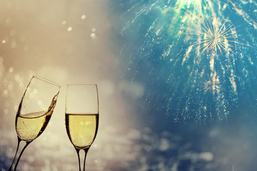 Champagne glasses on sparkling background